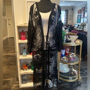 Lovely black lace tunic with tie in the front. One size .